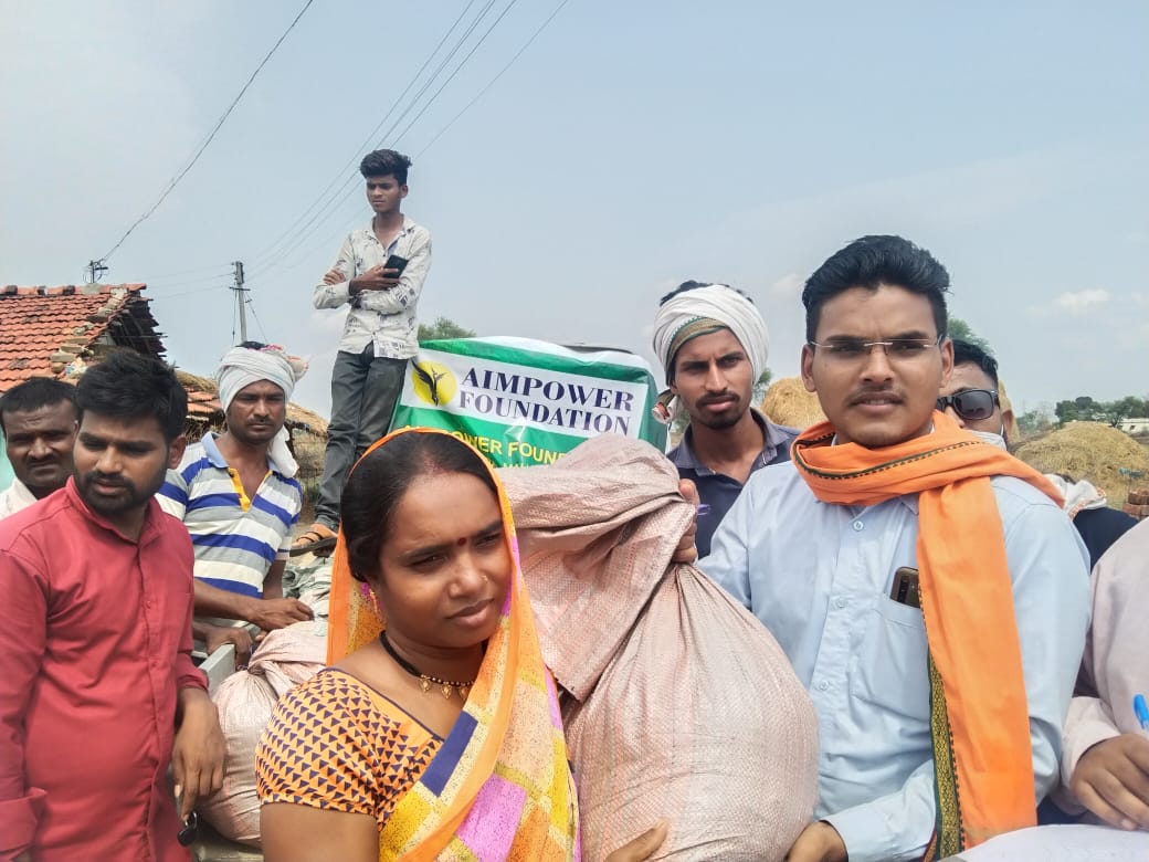 COVID-19 ration relief distribution with AIMPOWER banner